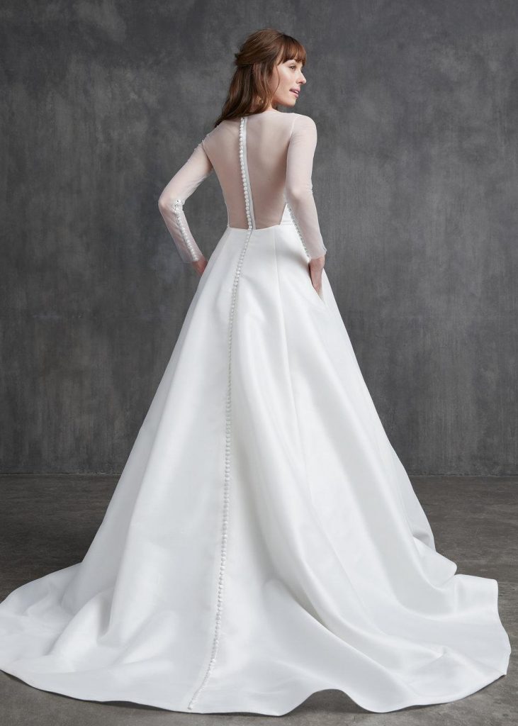 Back view of Kelly Faetanini ball gown with see-through top and buttons running down the back to the waist and up the sleeves from wrist to elbow. 